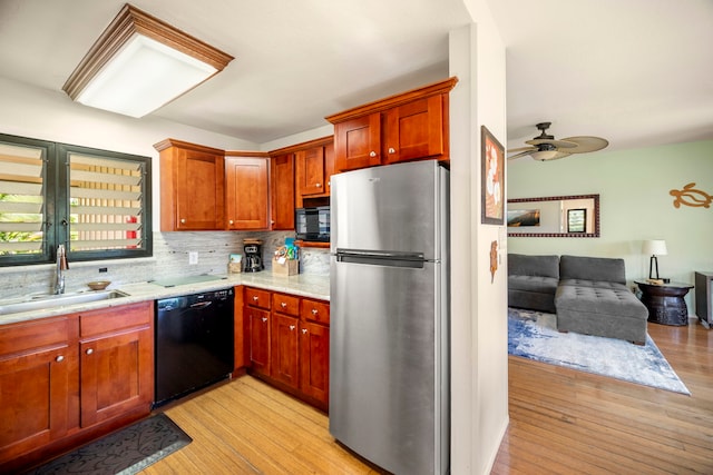 4460 Nehe Rd Unit 212, Lihue, HI 96766 - kitchen with black appliances, a sink, light wood-style floors, and backsplash
