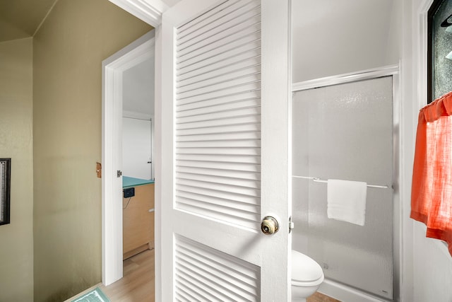 4460 Nehe Rd Unit 212, Lihue, HI 96766 - full bathroom featuring a shower stall, toilet, and wood finished floors