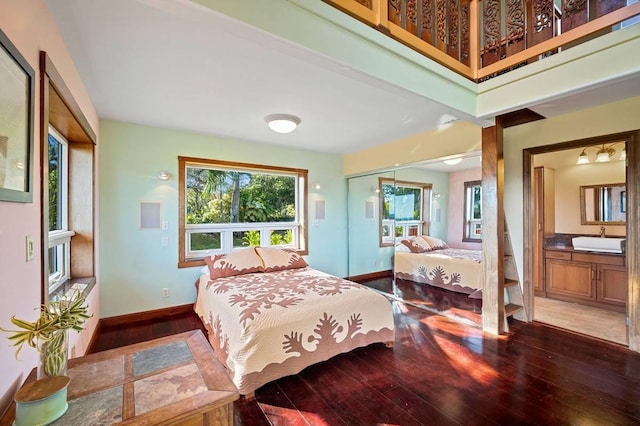 4-4940 Kuhio Hwy Unit A, Anahola, HI 96703 - bedroom featuring a sink, wood-type flooring, baseboards, a closet, and connected bathroom