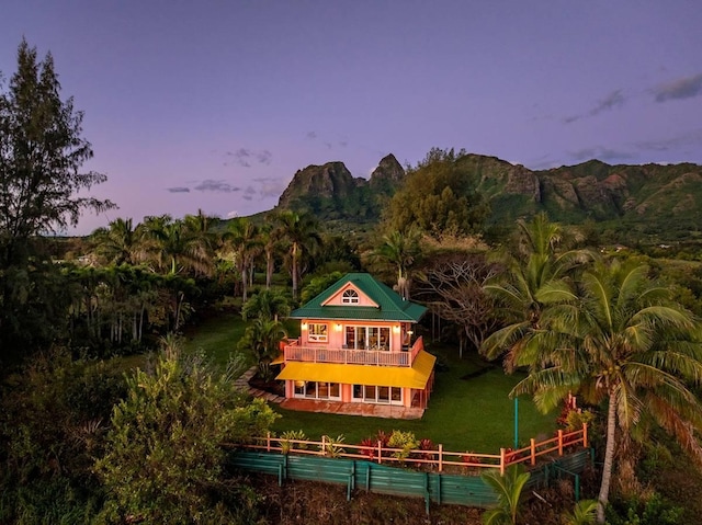 4-4940 Kuhio Hwy Unit A, Anahola, HI 96703 - back of house at dusk with a balcony