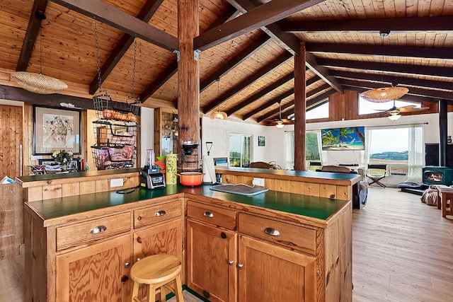 17-8160 N Kulani Rd, Mountain View, HI 96771 - kitchen with open floor plan, wood ceiling, dark countertops, a peninsula, and light wood finished floors