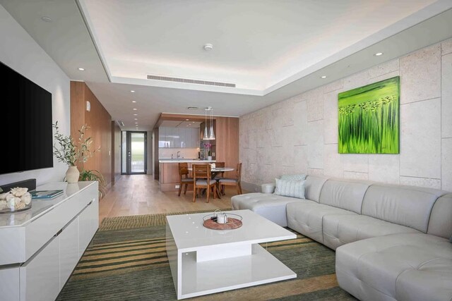 66-84 Kaunaoa Dr Unit C55, Kamuela, HI 96743 - living area featuring wood finished floors, a raised ceiling, and recessed lighting