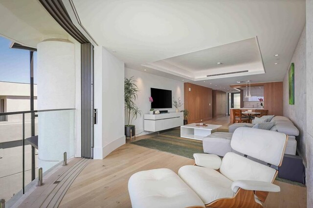 66-84 Kaunaoa Dr Unit C55, Kamuela, HI 96743 - living area with wood finished floors, a raised ceiling, and expansive windows
