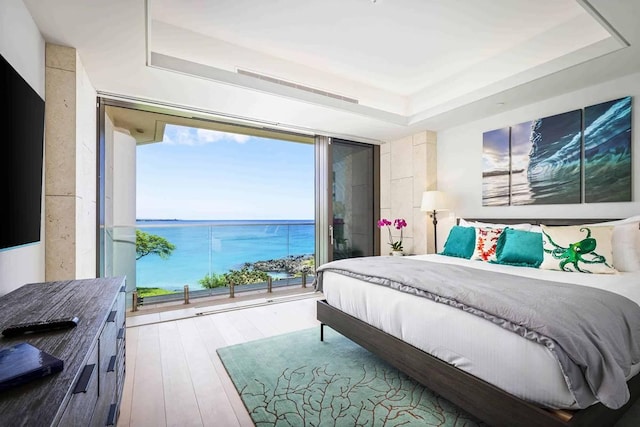 66-84 Kaunaoa Dr Unit C55, Kamuela, HI 96743 - bedroom with expansive windows, a raised ceiling, a water view, and hardwood / wood-style flooring