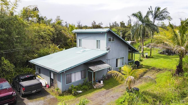 11-3171 Hibiscus St, Mountain View, HI 96771 - view of home's exterior featuring metal roof and a yard