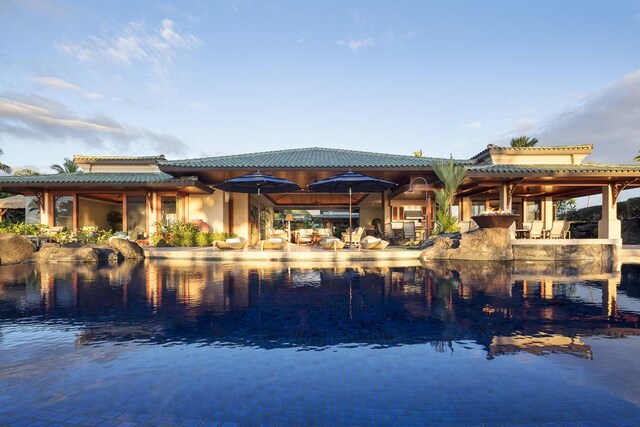 68-1015 Pauoa Way, Kamuela, HI 96743 - rear view of house featuring a water view, a tile roof, and stucco siding