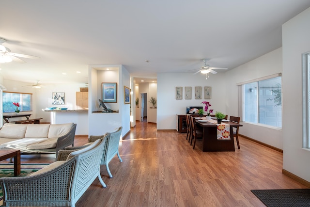 68-1693 Malie St, Waikoloa, HI 96738 - living area with a ceiling fan, light wood finished floors, and baseboards