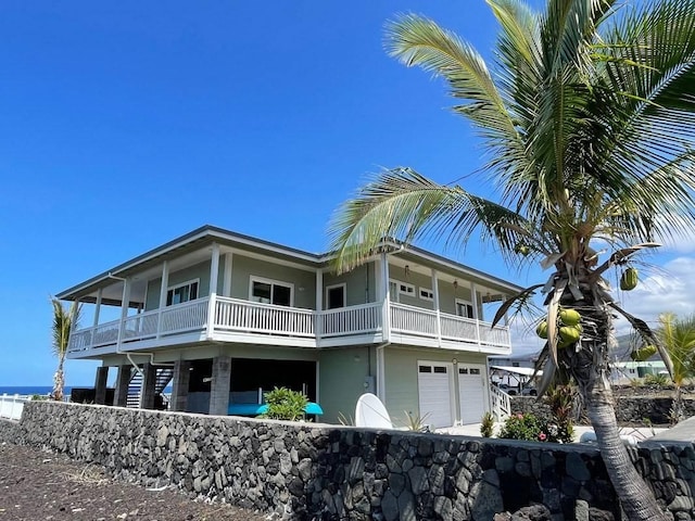 88-119 Kai Ave, Captain Cook, HI 96704 - view of property exterior with a balcony, an attached garage, and stucco siding