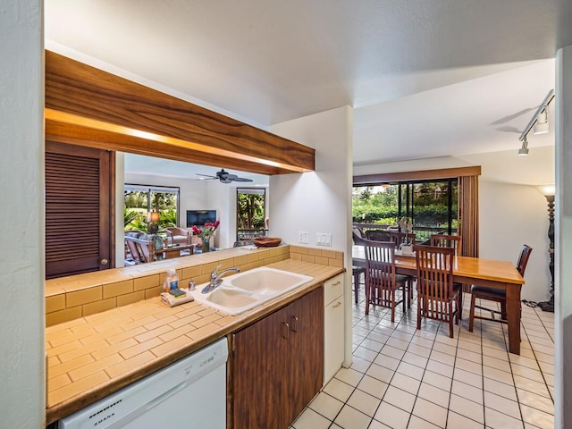 78-261 Manukai St Unit 201, Kailua-Kona, HI 96740 - kitchen featuring tile counters, dishwasher, a sink, light tile patterned floors, and rail lighting