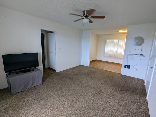 74-5618 Palani Rd Unit K4, Kailua-Kona, HI 96740 - unfurnished living room featuring ceiling fan, carpet, and a textured ceiling