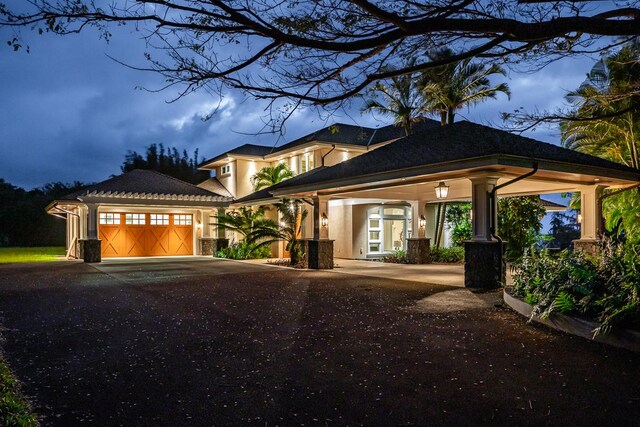 28-3320 Beach Rd, Pepeekeo, HI 96783 - view of front of property with an attached garage, asphalt driveway, and stucco siding