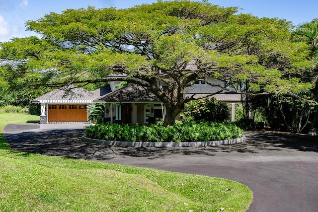 28-3320 Beach Rd, Pepeekeo, HI 96783 - obstructed view of property featuring a garage and asphalt driveway
