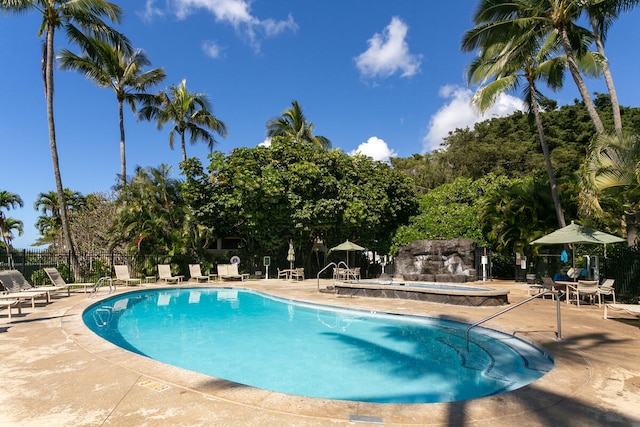 1831 Poipu Rd Unit 824, Koloa, HI 96756 - community pool featuring a hot tub, a patio area, and view of wooded area