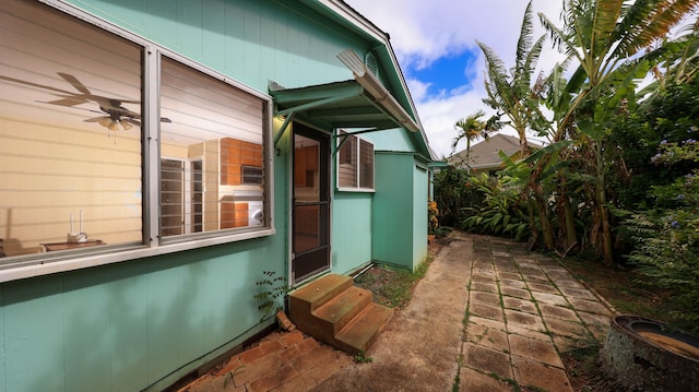 5118 Lawai Rd, Koloa, HI 96756 - view of side of property with entry steps, a ceiling fan, and a patio area