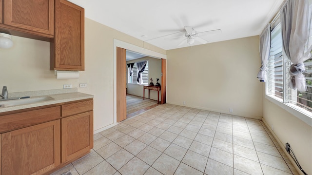 5118 Lawai Rd, Koloa, HI 96756 - kitchen featuring a sink, a ceiling fan, light countertops, light tile patterned flooring, and brown cabinetry