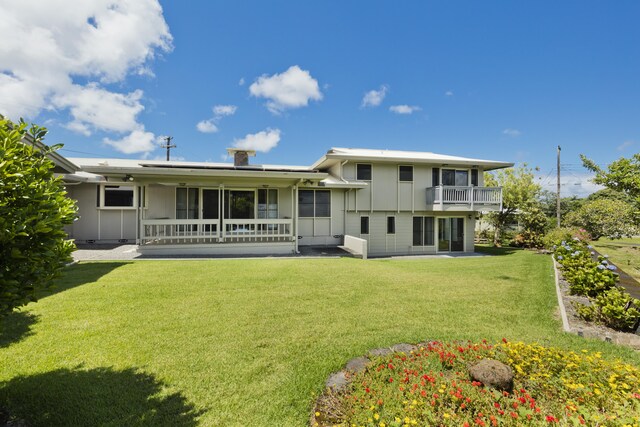 114 Kupaa St, Hilo, HI 96720 - back of property with a lawn, a balcony, and board and batten siding