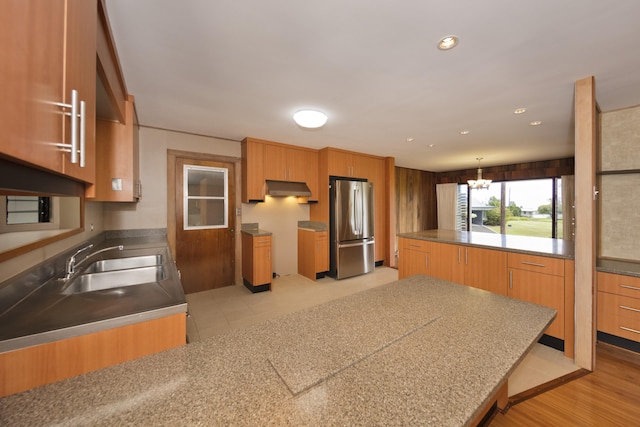 114 Kupaa St, Hilo, HI 96720 - kitchen featuring freestanding refrigerator, a sink, under cabinet range hood, recessed lighting, and brown cabinetry