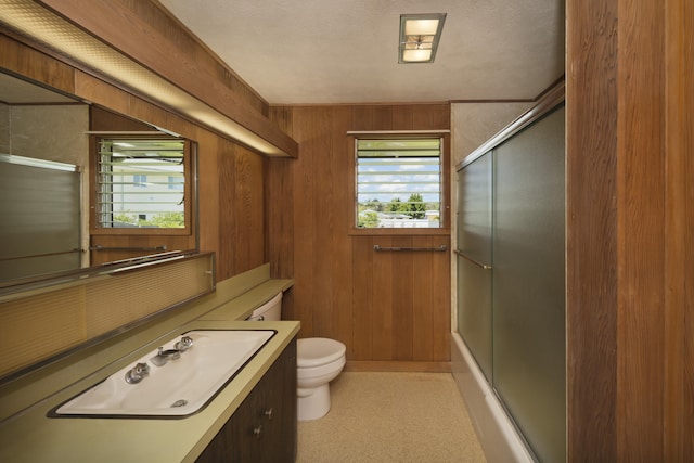 114 Kupaa St, Hilo, HI 96720 - bathroom with toilet, vanity, wood walls, and combined bath / shower with glass door