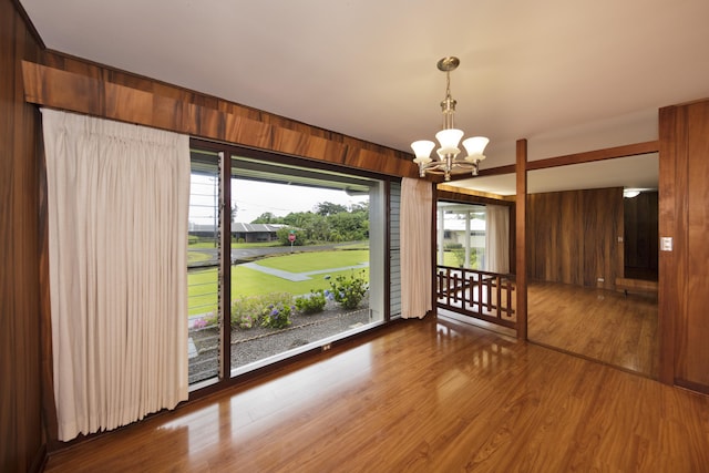 114 Kupaa St, Hilo, HI 96720 - unfurnished dining area featuring a chandelier, wood finished floors, and wood walls