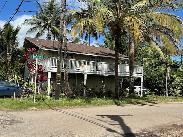 5404 Weke Rd, Hanalei, HI 96722 - beach home featuring a wooden deck and board and batten siding