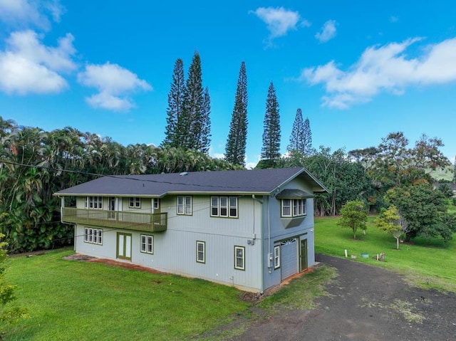 6573-E Puupilo Rd, Kapaa, HI 96746 - back of property featuring driveway, a garage, and a lawn