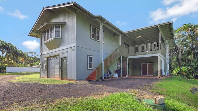 6573-E Puupilo Rd, Kapaa, HI 96746 - back of house with stairs, driveway, a garage, and a yard