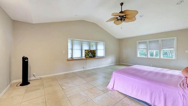 6573-E Puupilo Rd, Kapaa, HI 96746 - bedroom featuring multiple windows, vaulted ceiling, light tile patterned floors, and baseboards