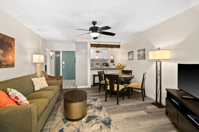 525 Aleka Lp Unit A3, Kapaa, HI 96746 - living room featuring wood finished floors, a textured ceiling, and a ceiling fan