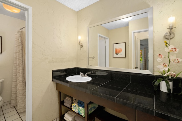 525 Aleka Lp Unit A3, Kapaa, HI 96746 - bathroom featuring toilet, tile patterned floors, a shower with shower curtain, a textured wall, and vanity