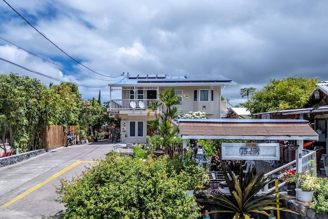 75-191 Ala Onaona St, Kailua-Kona, HI 96740 - view of front of property featuring solar panels, a balcony, and french doors