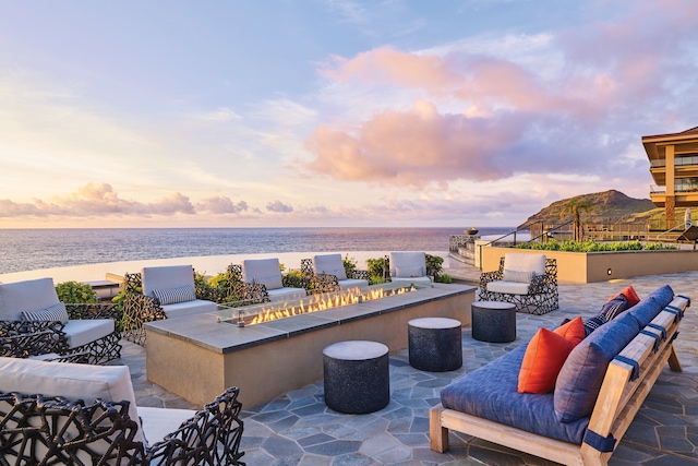 3770 Alaoli Way Unit 1002, Hokuala, HI 96766 - patio terrace at dusk with a patio, an outdoor living space with a fire pit, and a water view