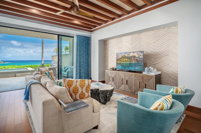 3770 Alaoli Way Unit 1002, Hokuala, HI 96766 - living room featuring an accent wall, wallpapered walls, wood finished floors, a water view, and beamed ceiling