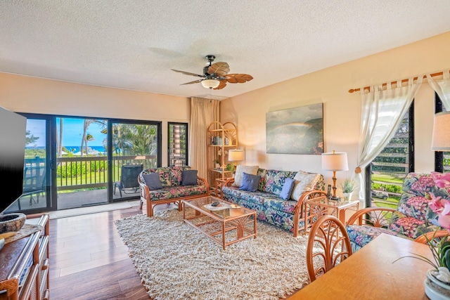 4460 Nehe Rd Unit 203, Lihue, HI 96766 - living room featuring wood finished floors, a textured ceiling, and ceiling fan
