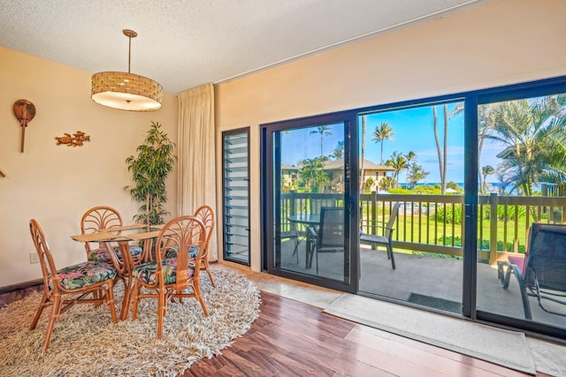 4460 Nehe Rd Unit 203, Lihue, HI 96766 - dining room featuring wood finished floors and a textured ceiling