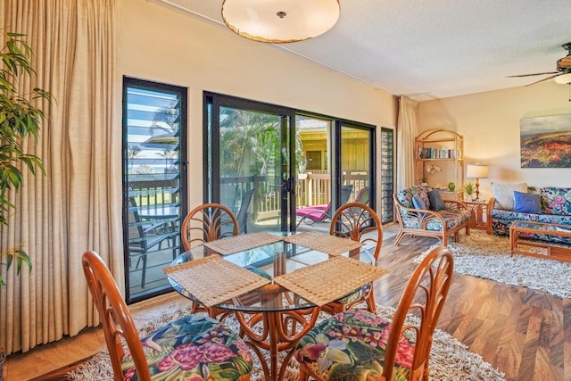 4460 Nehe Rd Unit 203, Lihue, HI 96766 - dining room featuring ceiling fan, light wood-style flooring, and a textured ceiling
