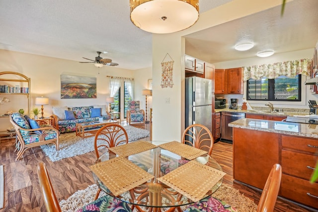 4460 Nehe Rd Unit 203, Lihue, HI 96766 - dining space with wood finished floors, a ceiling fan, and a textured ceiling