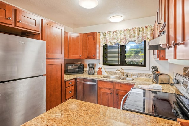 4460 Nehe Rd Unit 203, Lihue, HI 96766 - kitchen with appliances with stainless steel finishes, a sink, under cabinet range hood, brown cabinetry, and light stone countertops