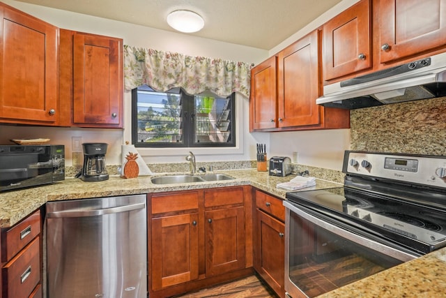 4460 Nehe Rd Unit 203, Lihue, HI 96766 - kitchen with stainless steel appliances, under cabinet range hood, a sink, and light stone countertops