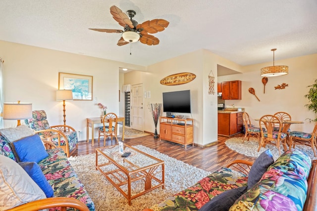 4460 Nehe Rd Unit 203, Lihue, HI 96766 - living room featuring wood finished floors, a ceiling fan, and a textured ceiling