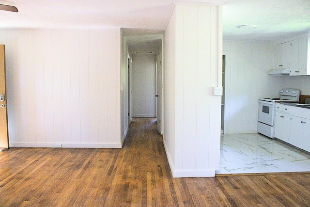 19-4035 Haunani Rd, Volcano, HI 96785 - kitchen featuring white electric stove, baseboards, extractor fan, wood finished floors, and wooden walls