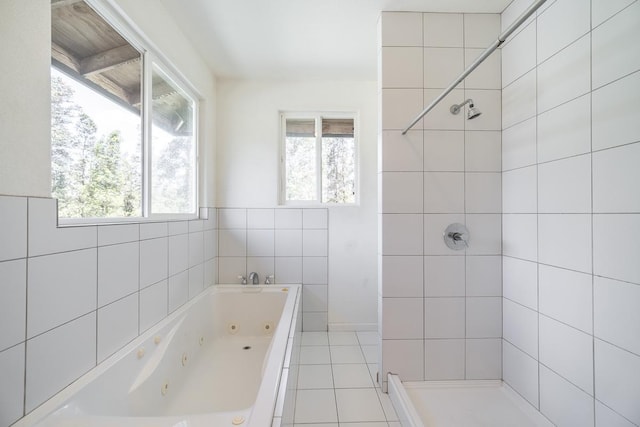 16-1366 Ao Rd, Mountain View, HI 96771 - bathroom featuring plenty of natural light, a whirlpool tub, tile patterned flooring, a tile shower, and tile walls