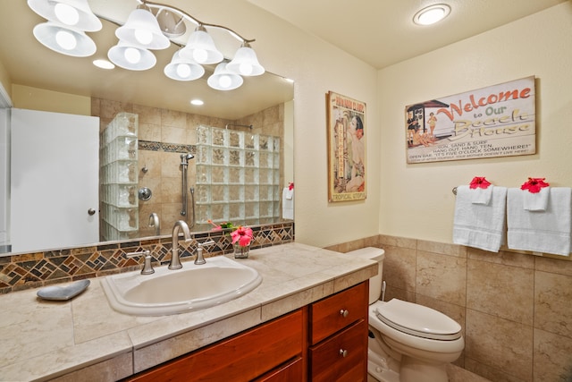 1901 Poipu Rd Unit 632, Koloa, HI 96756 - bathroom with tile walls, vanity, a shower stall, toilet, and a wainscoted wall