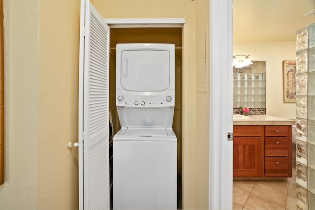 1901 Poipu Rd Unit 632, Koloa, HI 96756 - washroom featuring stacked washer / drying machine and light tile patterned flooring