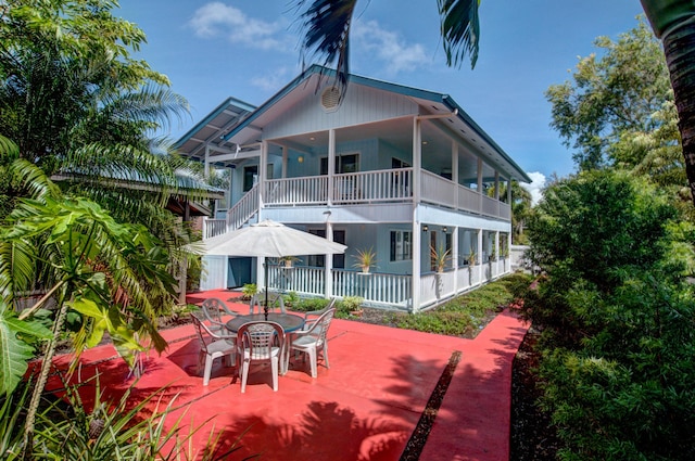 15-121 Kuna St, Pahoa, HI 96778 - back of house with a balcony, a patio area, and outdoor dining area
