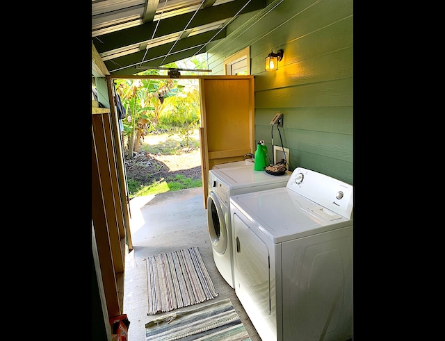 12-311 W Pohakupele Loop, Pahoa, HI 96778 - laundry area with washer and clothes dryer and wooden walls