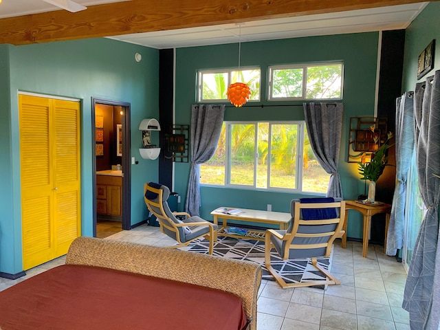 12-311 W Pohakupele Loop, Pahoa, HI 96778 - bedroom with multiple windows, light tile patterned floors, and connected bathroom