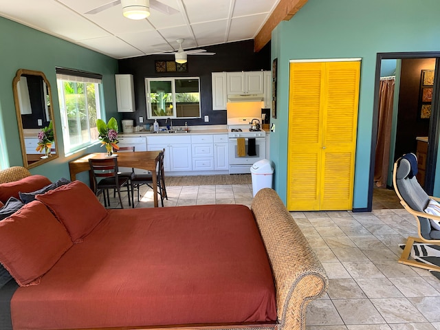 12-311 W Pohakupele Loop, Pahoa, HI 96778 - kitchen featuring gas range gas stove, a sink, under cabinet range hood, light countertops, and a ceiling fan