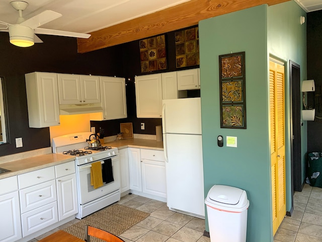 12-311 W Pohakupele Loop, Pahoa, HI 96778 - kitchen featuring white appliances, under cabinet range hood, and white cabinetry