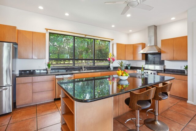 4564 Kapuna Rd, Kilauea, HI 96722 - kitchen featuring appliances with stainless steel finishes, wall chimney exhaust hood, a sink, a center island, and light tile patterned floors