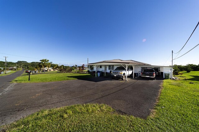127 Kanoelani St Unit 1, Hilo, HI 96720 - view of front of property with asphalt driveway, a front yard, and a carport